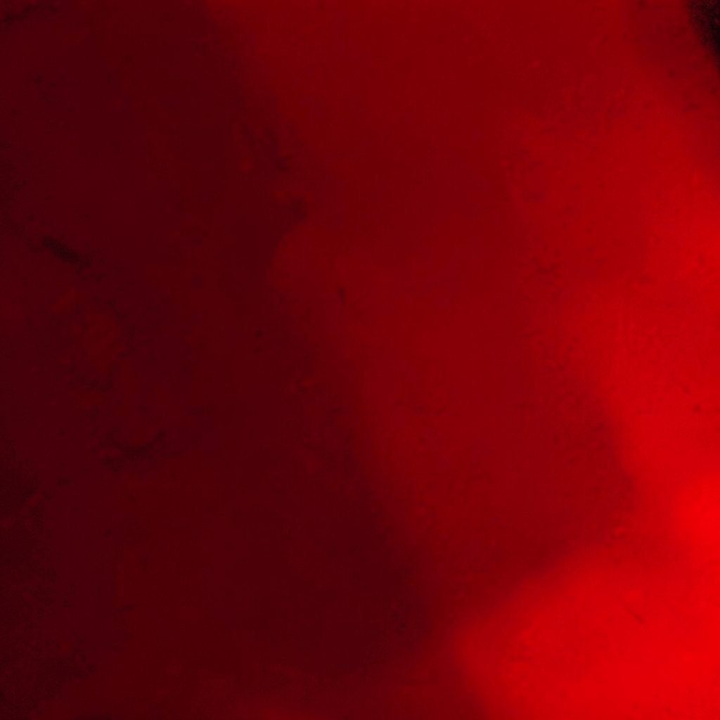 A quiet moment backstage, soft red glow, intimate atmosphere