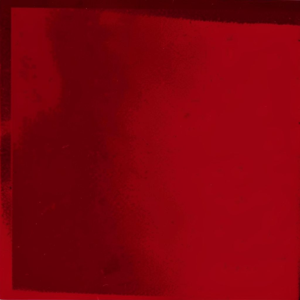 A close-up portrait in dramatic red and black duotone, soft expression, warm and intimate